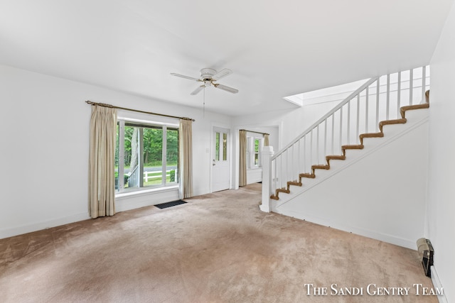 carpeted foyer entrance featuring ceiling fan