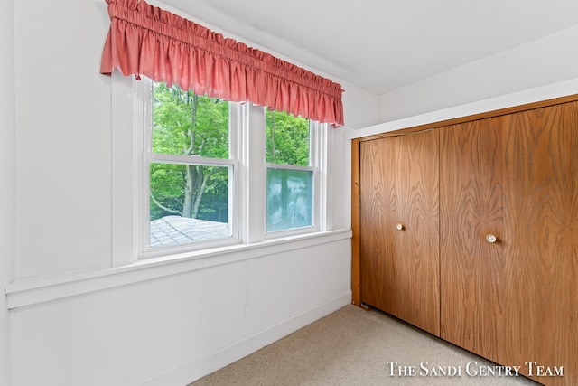 unfurnished bedroom with a closet and carpet floors