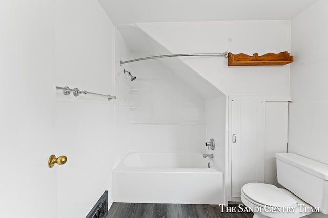 bathroom with hardwood / wood-style floors, toilet, and tub / shower combination