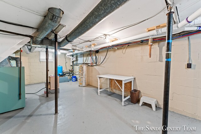 basement featuring gas water heater and heating unit