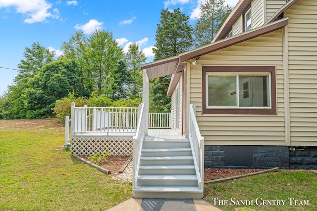 doorway to property with a yard