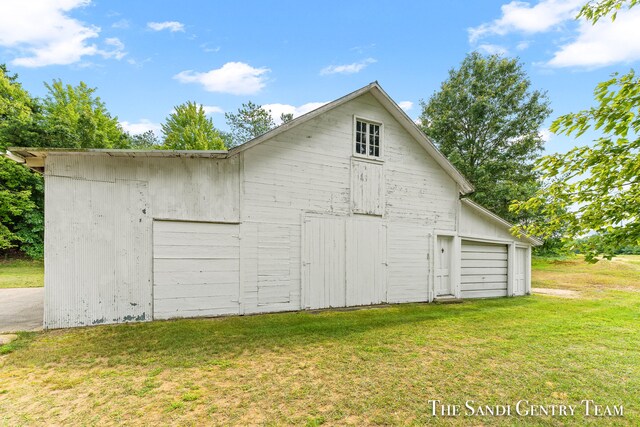 garage featuring a lawn