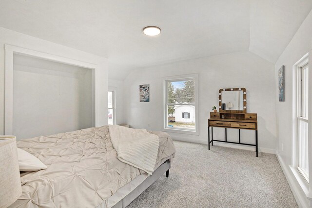 bedroom featuring carpet floors and vaulted ceiling