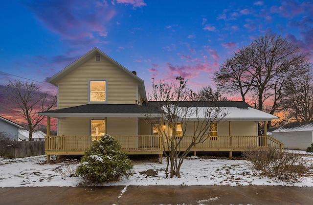 view of snow covered back of property