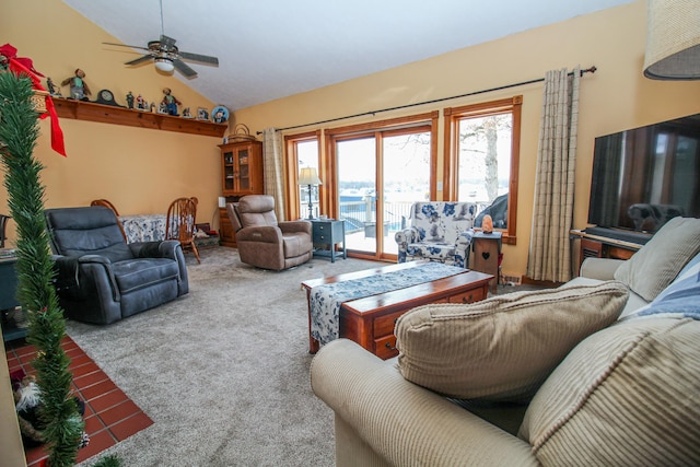 carpeted living room featuring ceiling fan and lofted ceiling