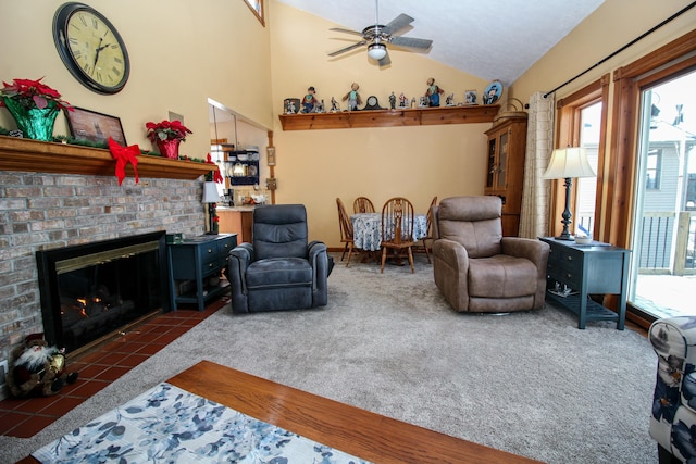 living room with a fireplace, dark tile patterned floors, vaulted ceiling, and ceiling fan