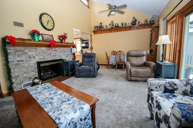 carpeted living room with ceiling fan, a fireplace, and high vaulted ceiling