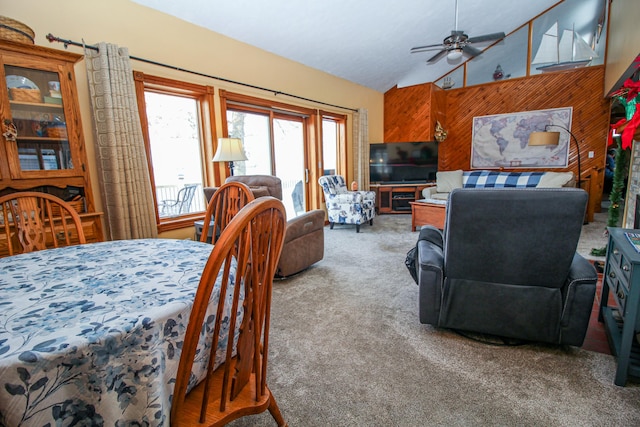 dining room with ceiling fan, carpet, and high vaulted ceiling