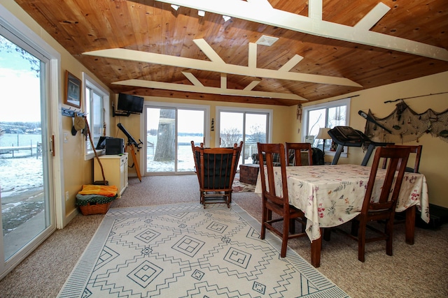 dining area featuring vaulted ceiling with beams, light colored carpet, and wood ceiling