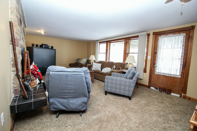 living room featuring carpet flooring and ceiling fan