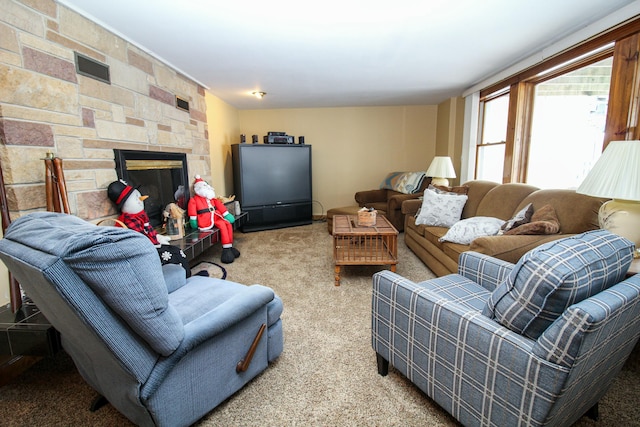 living room with a fireplace and light colored carpet