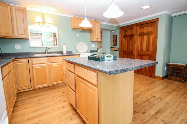 kitchen featuring sink, light brown cabinets, crown molding, pendant lighting, and light hardwood / wood-style floors