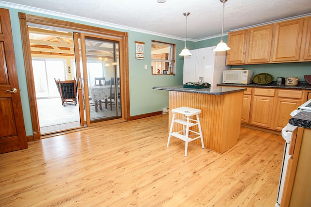 kitchen featuring a center island, white appliances, light wood-type flooring, decorative light fixtures, and a breakfast bar area