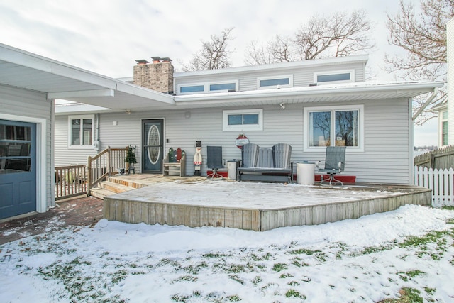 snow covered property featuring a deck