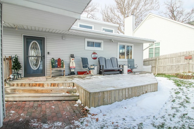 snow covered rear of property featuring a wooden deck