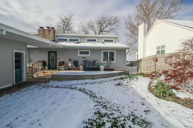 view of snow covered back of property