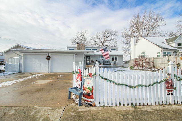 view of front of property with central AC unit and a garage