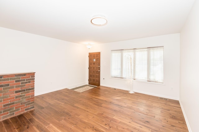 unfurnished room with hardwood / wood-style flooring