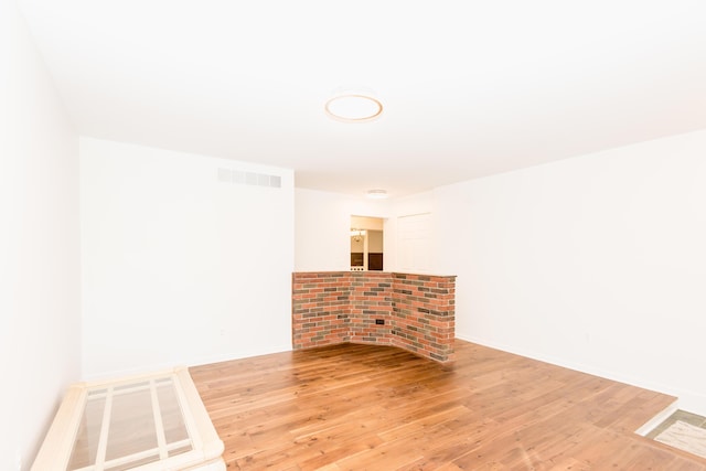 spare room with hardwood / wood-style floors