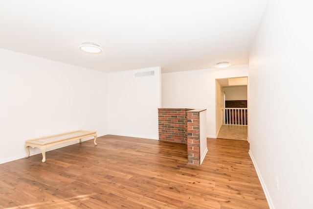 spare room featuring wood-type flooring