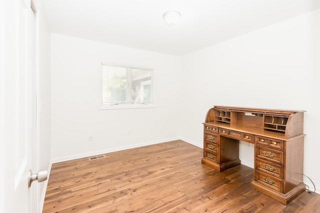 unfurnished office with wood-type flooring