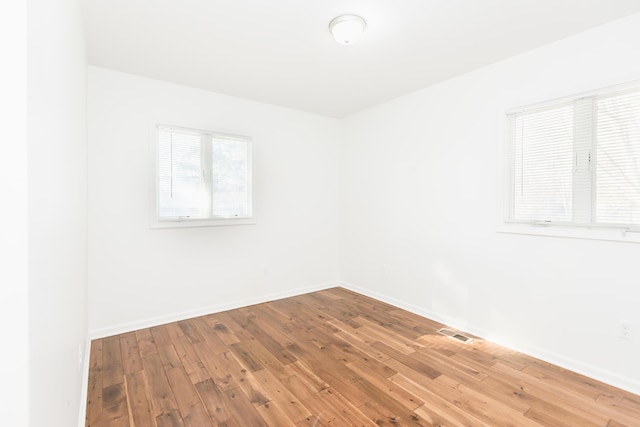 spare room with hardwood / wood-style floors