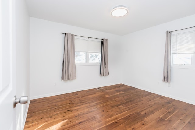 empty room with hardwood / wood-style floors