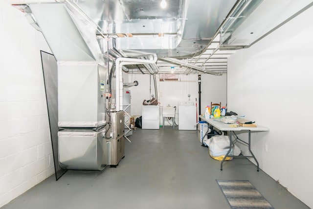 basement with separate washer and dryer and sink