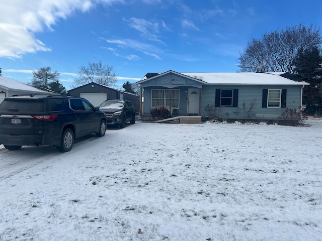 view of front of house featuring a garage and an outbuilding