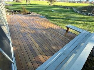 wooden terrace with a lawn