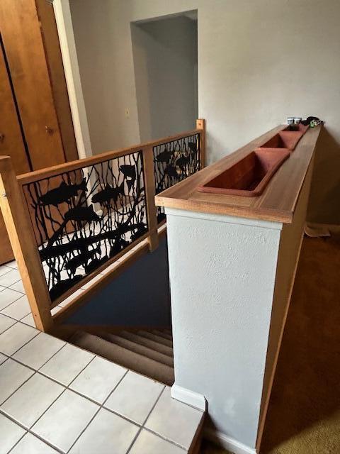 stairway with tile patterned flooring