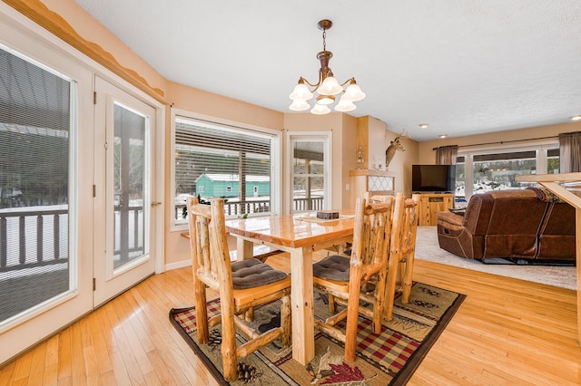 dining area with an inviting chandelier and light wood-type flooring