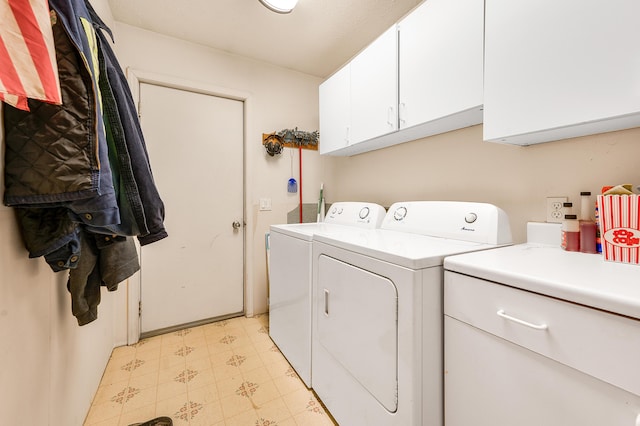 laundry room featuring cabinets and separate washer and dryer