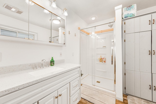 bathroom featuring vanity and hardwood / wood-style flooring