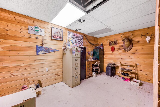 home office with wooden walls and concrete floors