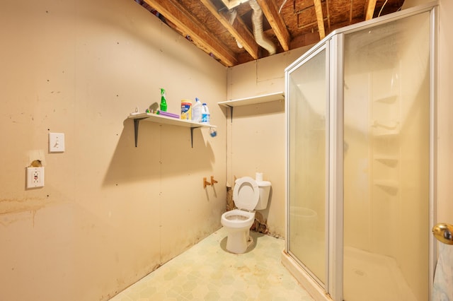 bathroom with toilet and a shower with shower door