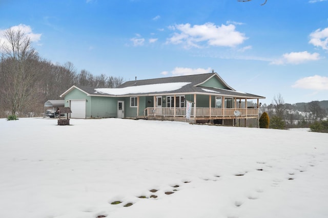 snow covered house featuring covered porch