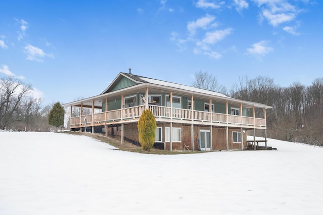 view of snow covered rear of property