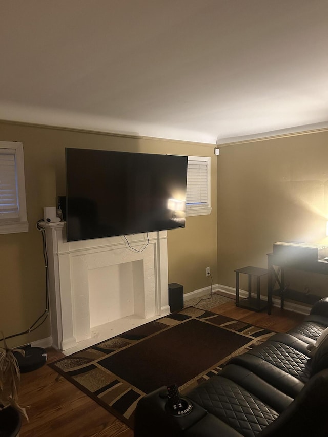 living room with dark hardwood / wood-style flooring and ornamental molding