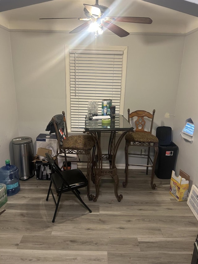 dining space with wood-type flooring and ceiling fan