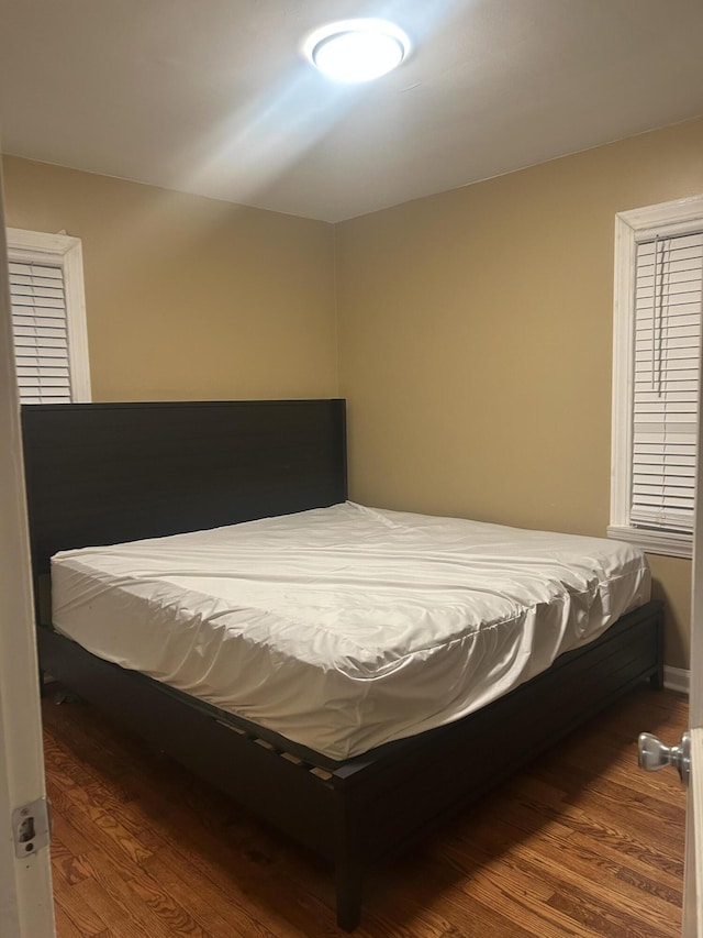 bedroom featuring dark wood-type flooring