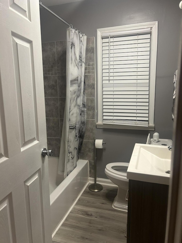 full bathroom featuring vanity, toilet, shower / bath combo, and wood-type flooring