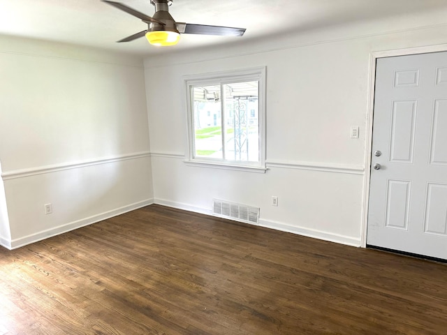 empty room featuring dark hardwood / wood-style floors and ceiling fan