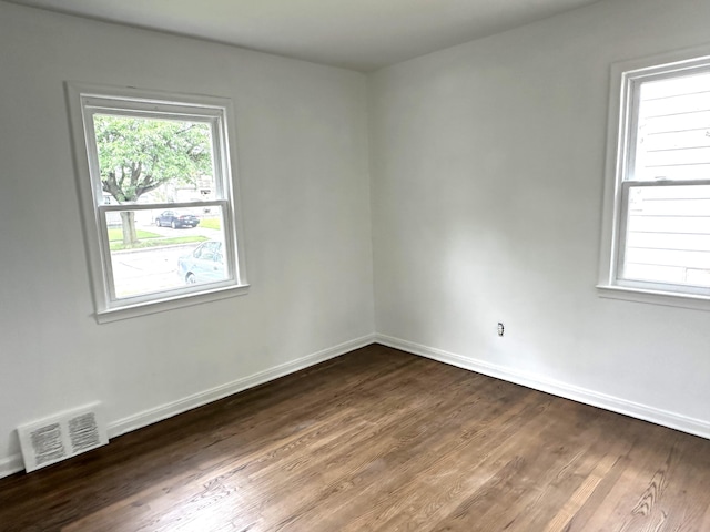 unfurnished room featuring dark hardwood / wood-style flooring