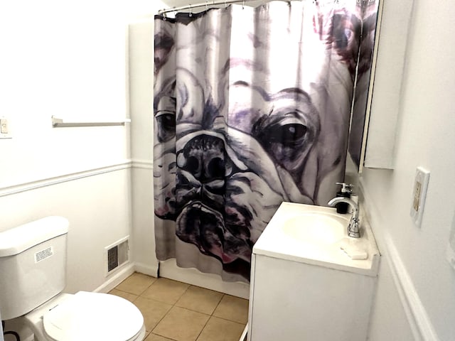 bathroom with tile patterned flooring, vanity, and toilet