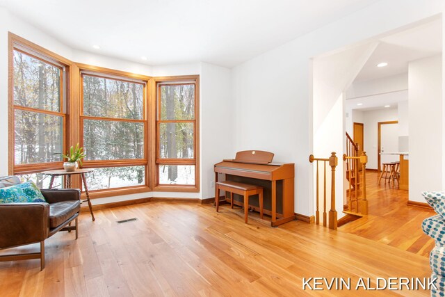 sitting room with hardwood / wood-style flooring