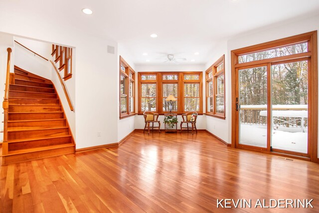 unfurnished living room featuring light hardwood / wood-style flooring and ceiling fan