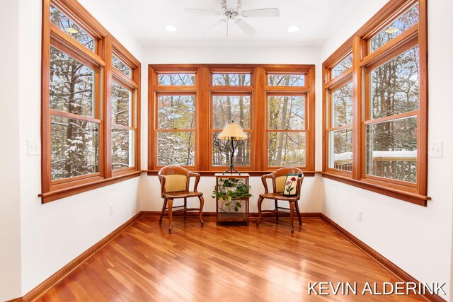 unfurnished sunroom featuring ceiling fan and plenty of natural light