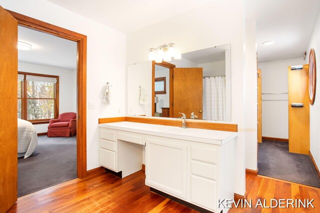 bathroom featuring hardwood / wood-style flooring and vanity