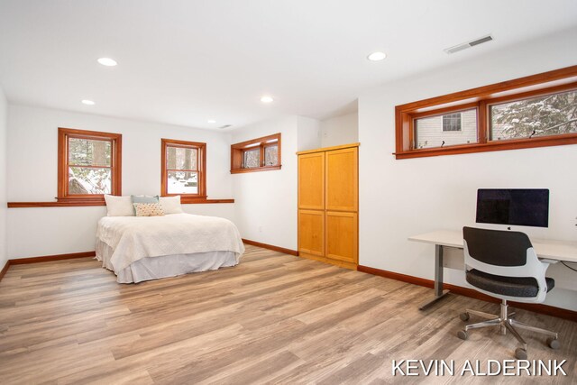 bedroom with light wood-type flooring and a closet